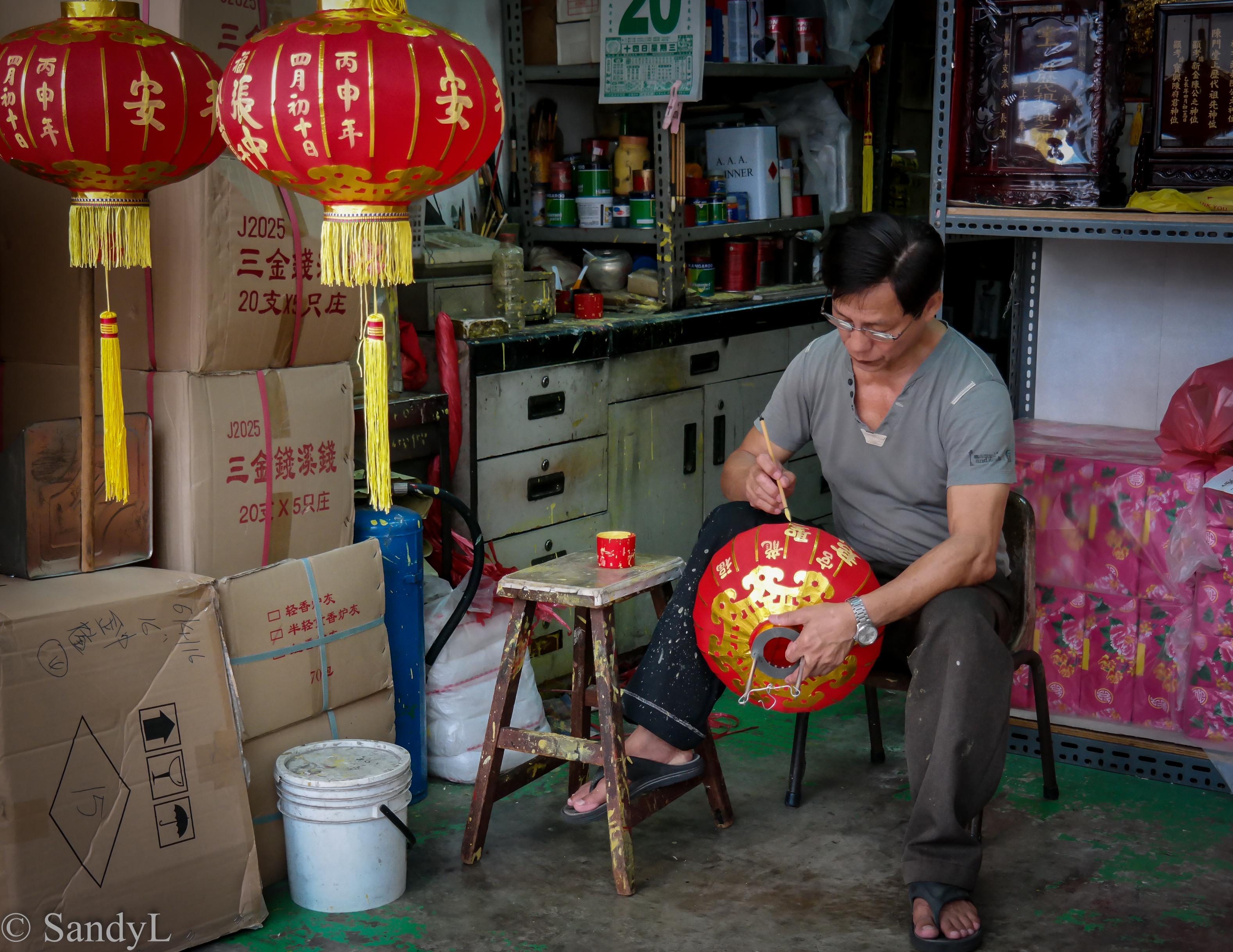 Man painting red latern for Chinese New Year