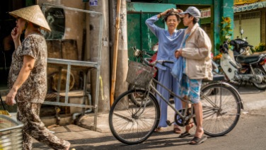 Saigon street scene with three ladies in Cholon market